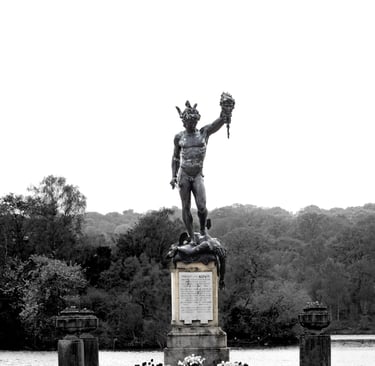 A Statue of Perseus holing the head of medusa in black and white