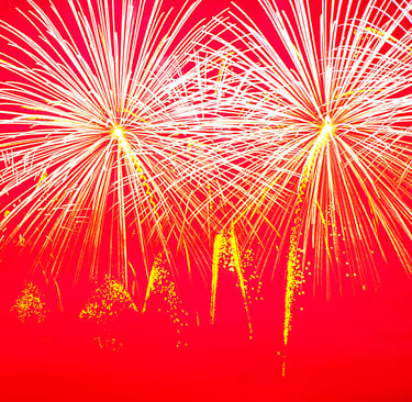 white fireworks against a pink backdrop