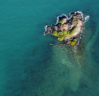 a small island with a small island in the middle of the ocean