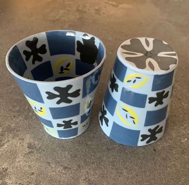 Blue and black cups with patterns inside and out
