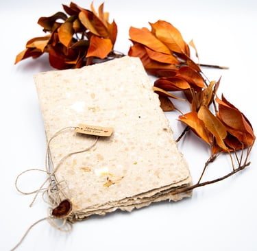 A book of handmade paper with some leaves