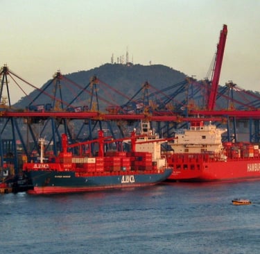 a large ship in the water with a boat in the background