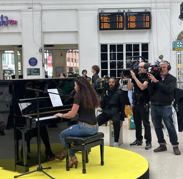 Helen Spooner performing "Sweet Child O' Mine" at Brighton Station for The Piano on Channel 4