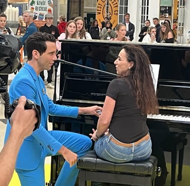 Mika talking to Helen Spooner after her performance on The Piano on Channel 4 at Brighton Station
