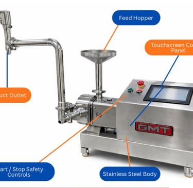Industrial stainless steel food processing machine with touchscreen control panel and product outlet.