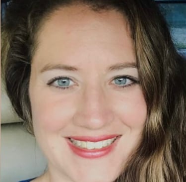 a woman with long hair and blue eyes and a blue shirt