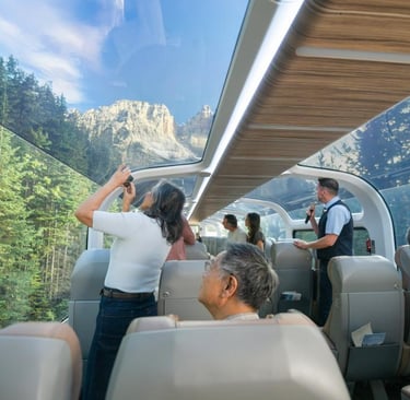 A group on Rocky Mountaineer Rail looking out a glass dome train car