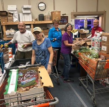 Rose Garden Volunteers sorting food donations and assembling grocery bags for neighbors