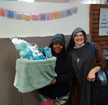 Baby boy is due soon! Mom gets a dinosaur baby basket at the Rose Garden Mission