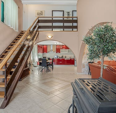 Villa Nika interior – open space with kitchen and staircase to upstairs bedrooms.