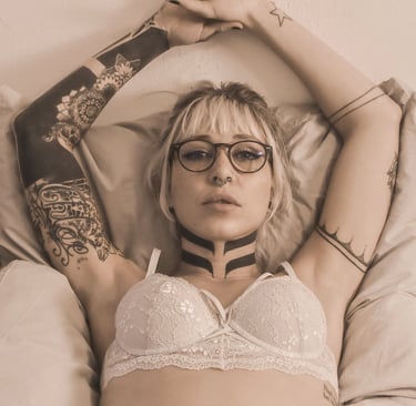 a woman with tattoos on her chest and a braille braille braille bra