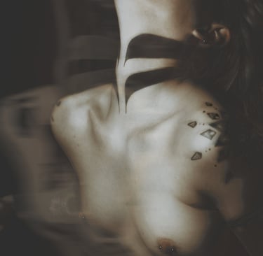 a woman with tattoos on her chest and neck