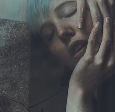 a woman with blue hair, close eyes, seen throught a window