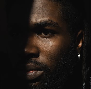 a man with a beard half face in shadow half in the light