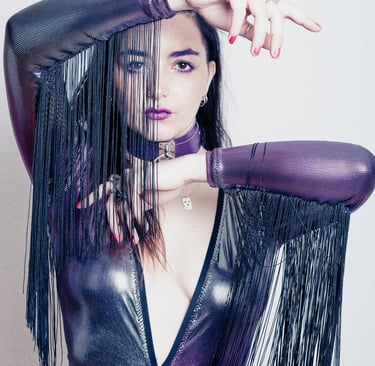 a woman in a violet fantasy suit with afringes