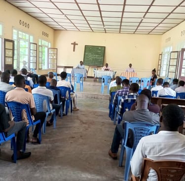 a group of students of UCGB sitting in chairs in a room