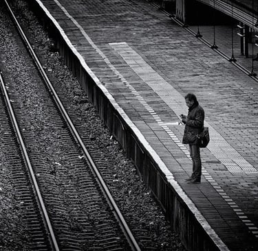 Solitary man standing on train station platform