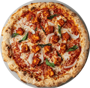 Freshly baked paneer ghee roast pizza with onions and curry leaves on a crispy crust.