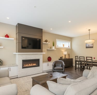 Modern open concept living room and dining area featuring a gas fireplace and wall-mounted TV.