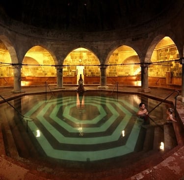 a man standing in a large room with a large pool