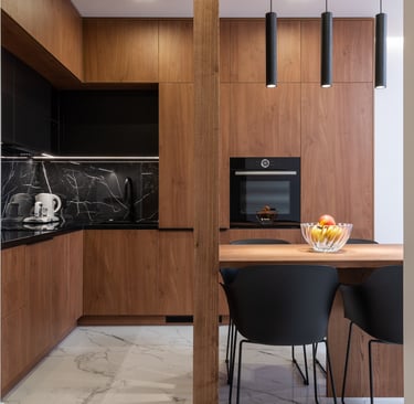 a kitchen with a table and chairs and a bowl of fruit