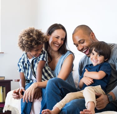 a family of three sitting on a couch