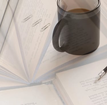 a cup of coffee and a pen on a table