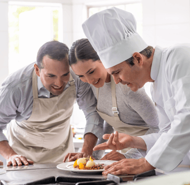 Couple taking a cooking class with personal chef