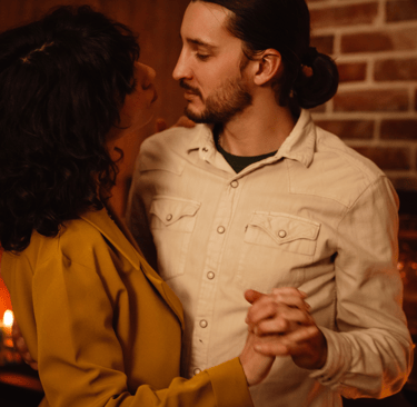 Couple dancing to romantic music with candlelight