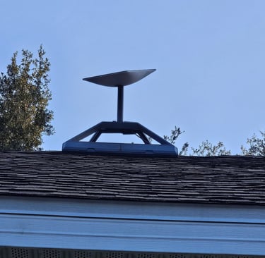 A Starlink satellite internet dish mounted on a residential roof for high-speed connectivity.