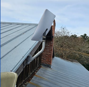 Starlink satellite internet dish mounted on a metal roof for high-speed rural connectivity.