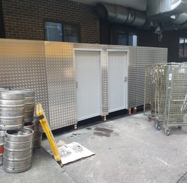 timber built smoking shelter and barrel store