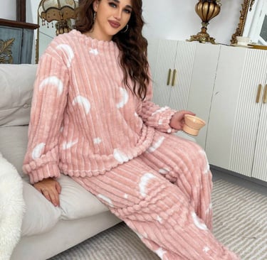 Stay warm and cozy in this soft plush pajama set with moon & star print