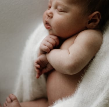 Newborn photography session in Adelaide Hills capturing mother holding baby naturally