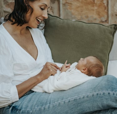 natural, lifestyle newborn photograph of baby looking up at mom