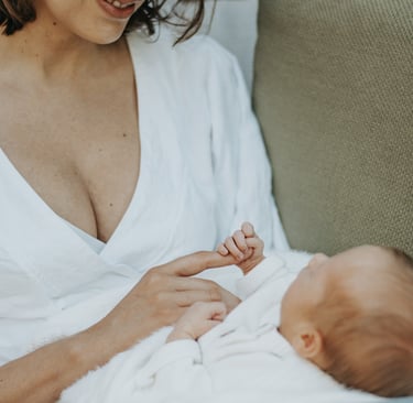 natural, lifestyle newborn photograph of baby holding on to moms finger