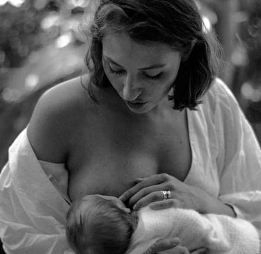 natural, lifestyle newborn photograph of baby breastfeeding 