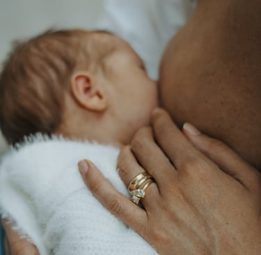natural, lifestyle newborn photograph of baby breastfeeding