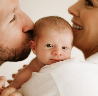 newborn in parents arms, in studio shoot Littlehampton