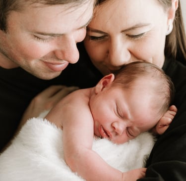 Mother holding newborn during relaxed Adelaide Hills newborn photography session