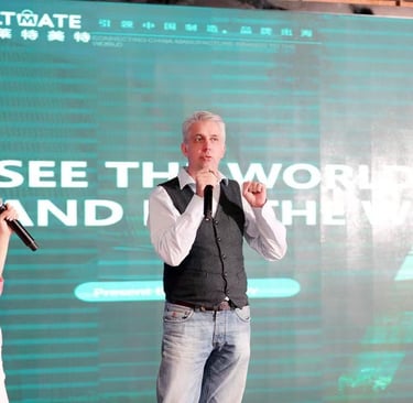 a man and woman standing in front of a large screen