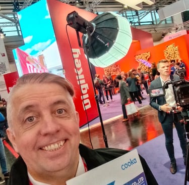 a man holding a book in front of a camera