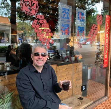 a man sitting on a bench in front of a store