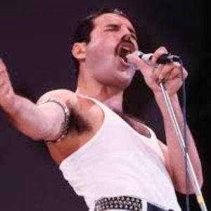 a man in a white tank top and black pants