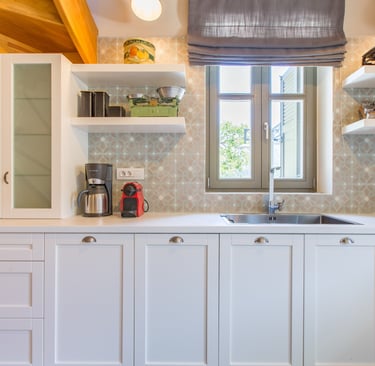 Kitchen interior with sink and window view at Villa Skyphos, Crete
