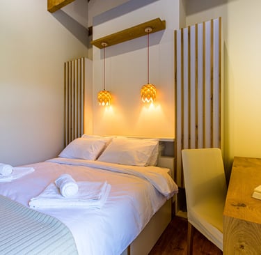 Stylish double bedroom with wooden ceiling and natural light at Villa Skyphos, Crete