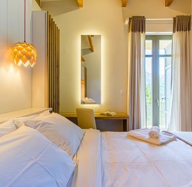 Cozy bedroom corner with hanging lamp and soft lighting at Villa Skyphos
