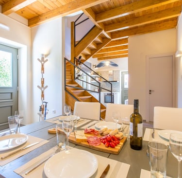 Dining table set with local Cretan wine and delicacies at Villa Skyphos