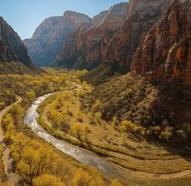 Scenic view of Zion National Park with a winding river, vibrant yellow trees, and towering red rock cliffs under a clear blue