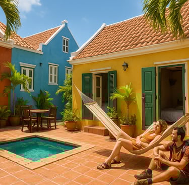 olorful Caribbean-style guesthouse courtyard in Curaçao with a small pool, palm trees, and a couple relaxing — one in a hammo